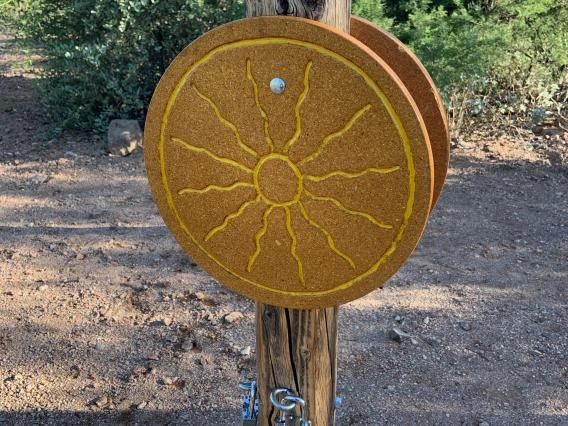 Sun sign on post with locks